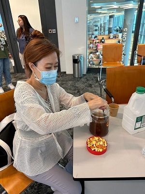 Participants learning how to upcycle t-shirts into tote bags and create enzyme cleaner